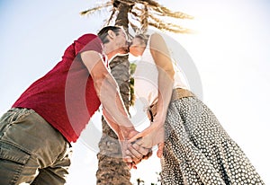 Romantic couple in love kissing on tropical island vacation