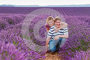 Romantic couple in love in lavender fields in Provence, France. Beautiful young man and woman hugging at sunset. Wedding