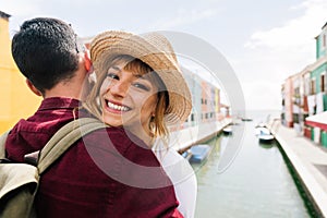 Romantic couple in love visiting Venice, Italy - Boyfriend and girlfriend enjoying holidays walking in the city