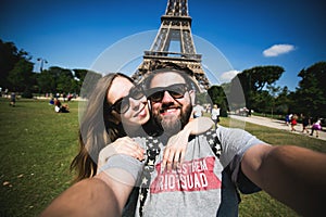 Romantic couple making selfie in front of Eiffel