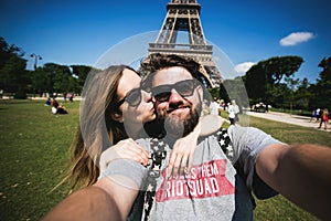 Romantic couple making selfie in front of Eiffel