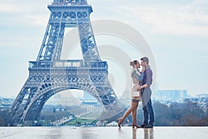 Romantic couple near the Eiffel tower in Paris, France