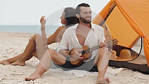 Romantic Couple Near a Tent on the Beach