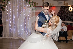 Romantic couple of newlyweds first elegant dance at wedding reception hall