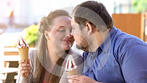 Romantic couple nuzzling holding sweet ice-cream in hands, diabetes risk