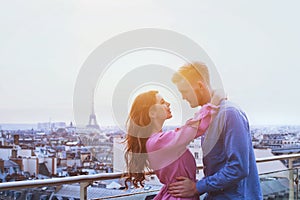 Romantic couple in Paris, happy moment on Eiffel Tower background