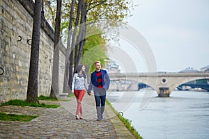 Romantic couple in Paris near the Seine