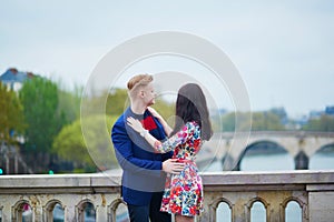 Romantic couple in Paris near the Seine