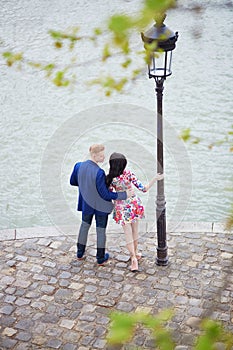 Romantic couple in Paris near the Seine