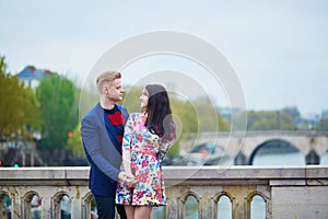 Romantic couple in Paris near the Seine