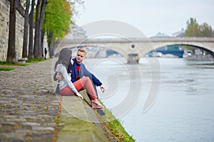 Romantic couple in Paris near the Seine