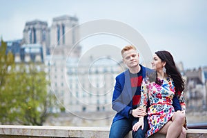 Romantic couple in Paris near the Seine
