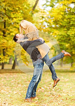 Romantic couple playing in the autumn park
