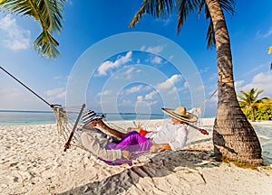 Romantic Couple Relaxing In Beach Hammock