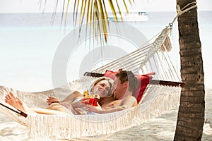 Romantic Couple Relaxing In Beach Hammock