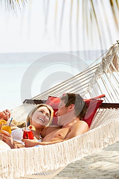 Romantic Couple Relaxing In Beach Hammock