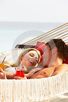 Romantic Couple Relaxing In Beach Hammock