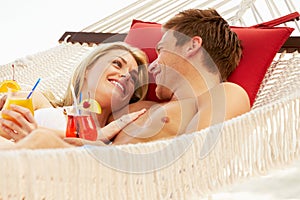 Romantic Couple Relaxing In Beach Hammock