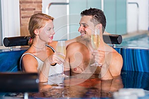 Romantic couple is relaxing with glasses of vine