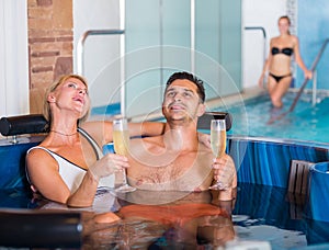 Romantic couple is relaxing with glasses of vine