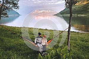 Romantic couple relaxing in hammock outdoor man and woman traveling together in Norway family lifestyle