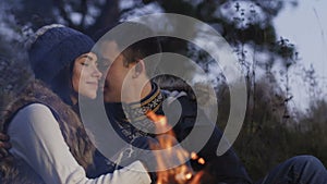 Romantic couple resting at bonfire in calm. Slowly