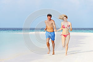 Romantic Couple Running On Beautiful Tropical Beach