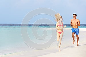 Romantic Couple Running On Beautiful Tropical Beach