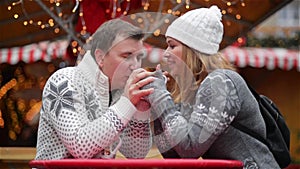 Romantic Couple Smiling on the Christmas Fair, Young Family Spends Time Together on Winter Holiday. Merry Christmas and