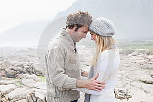 Romantic couple standing on a rocky landscape
