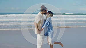 Romantic couple standing at seashore, kissing