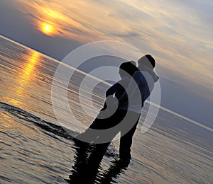 Romantic couple at sunset photo