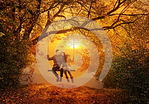 Romantic couple swing in the autumn park photo