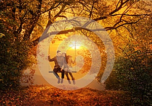 Romantic couple swing in the autumn park