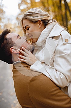 Romantic couple walking in autumn forest and kissing