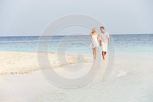 Romantic Couple Walking On Beautiful Tropical Beach