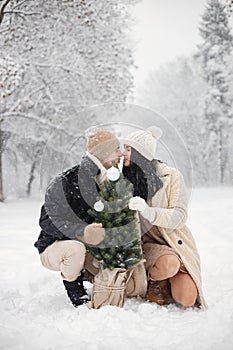 Romantic couple walking in forest at winter day