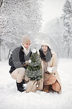 Romantic couple walking in forest at winter day