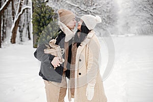 Romantic couple walking in forest at winter day