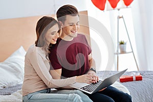 Romantic couple working on laptop together