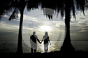 Romantic couples, young handshake at sunrise or sunset