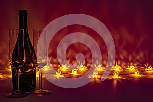 Romantic cozy evening with empty glasses and bottle of champagne