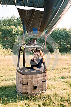 Romantic date, marriage proposal, engagement, wedding anniversary concept. Couple in love sitting in the basket of hot