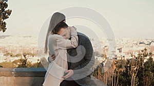 Romantic date of young beautiful couple, panorama of Rome, Italy on background. Man and woman hug, kiss, take a selfie.