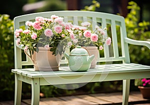 Romantic detail of the watering can with beautiful flowers on a garden bench, to beautify the garden photo