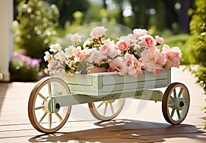 Romantic detail of the watering can with beautiful flowers on a garden bench, to beautify the garden