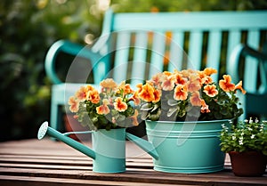 Romantic detail of the watering can with beautiful flowers on a garden bench, to beautify the garden