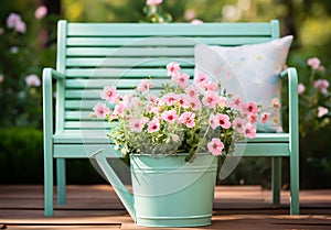 Romantic detail of the watering can with beautiful flowers on a garden bench, to beautify the garden photo