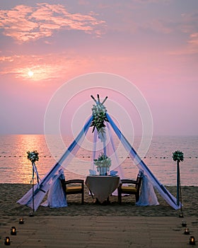 Romantic dinner on the beach, honemoon dinner on the beach during sunset Thailand, valentine setting