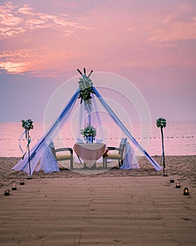 Romantic dinner on the beach, honemoon dinner on the beach during sunset Thailand, valentine setting